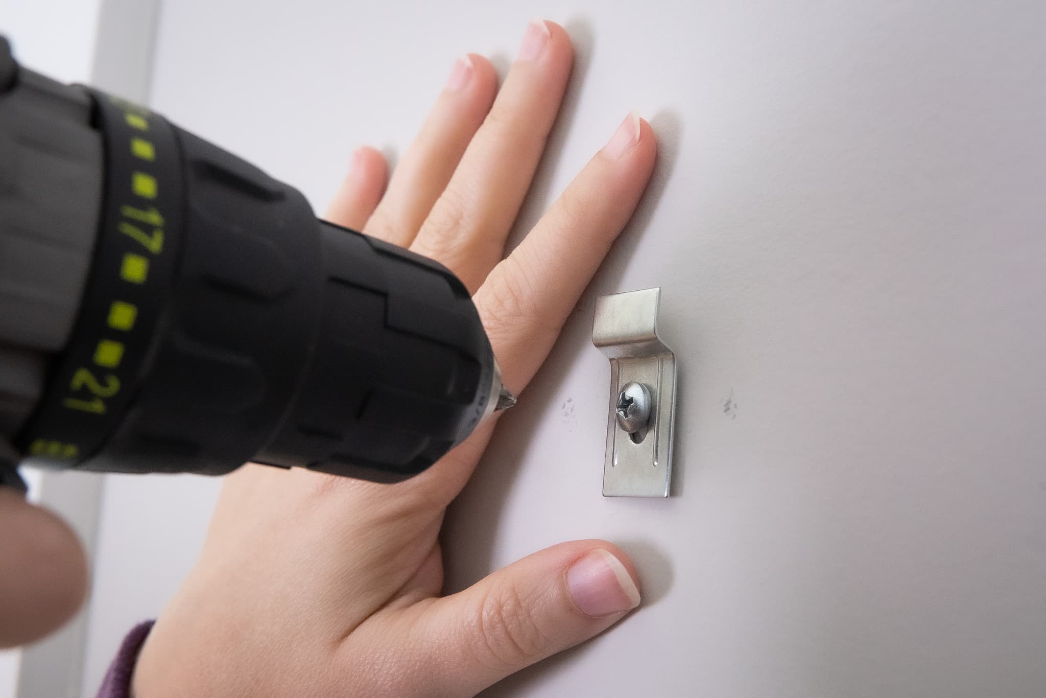 Installing wall bracket with security T-screw for theft-deterrent picture frame mounting