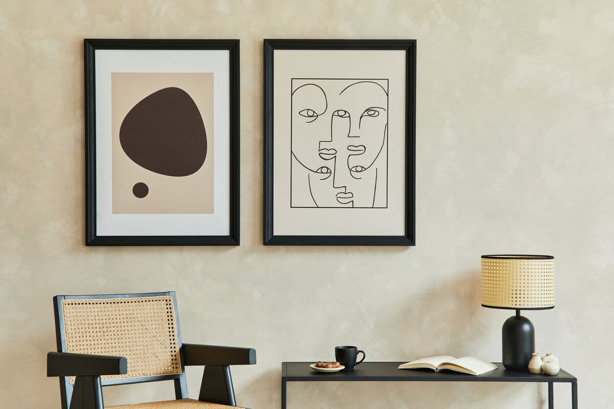 Modern Black Frame in minimalist living room setting displaying abstract art and modern line drawings with white matting creating sophisticated contemporary gallery wall