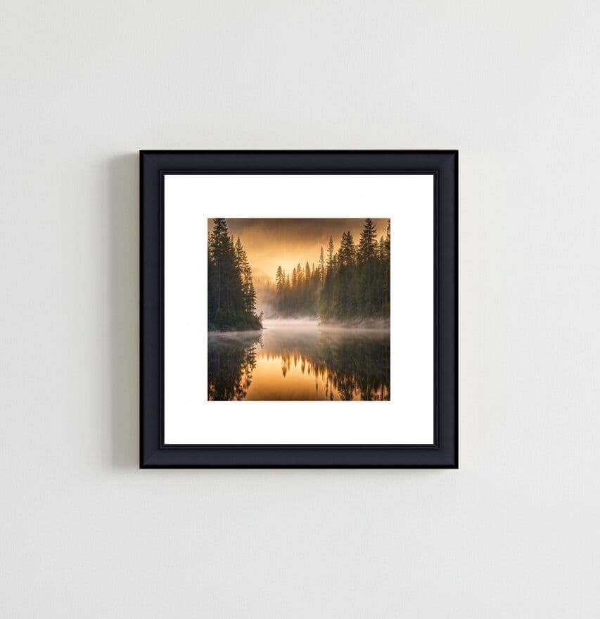 Modern Black frame displaying misty forest landscape photography with white mat in minimalist interior showcasing professional photography presentation