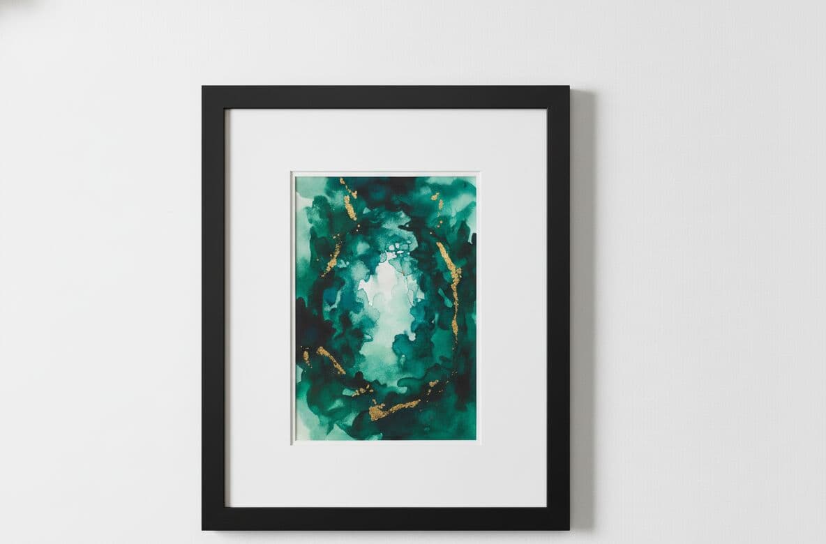 Black Picture frame with white mat displaying dramatic emerald teal and turquoise abstract watercolor painting with gold metallic accents mounted on pristine white wall in minimalist gallery setting demonstrating clean contemporary framing for fluid art and abstract alcohol ink paintings with professional museum-quality presentation