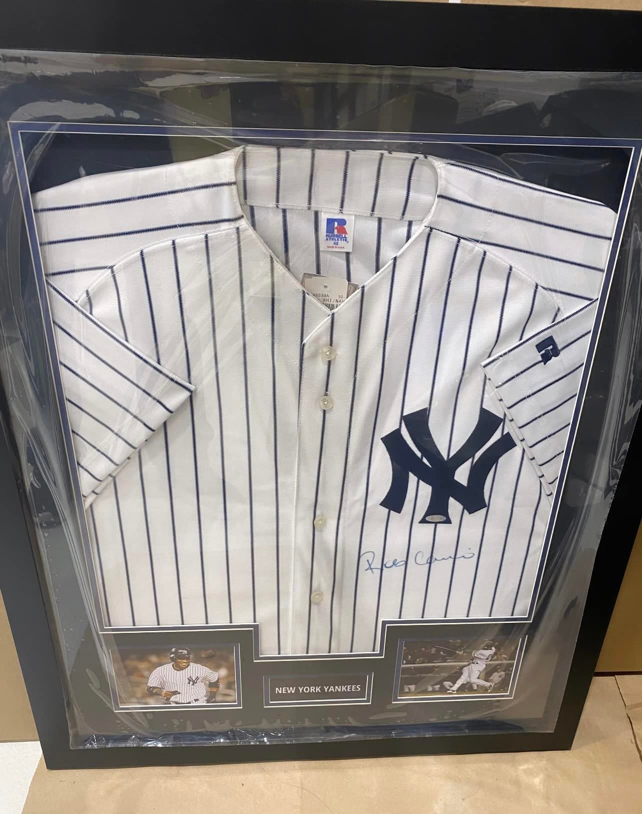 Signed Robinson Cano New York Yankees home pinstripe jersey framed in a black shadow box with twin action shots and engraved 'New York Yankees' nameplate
