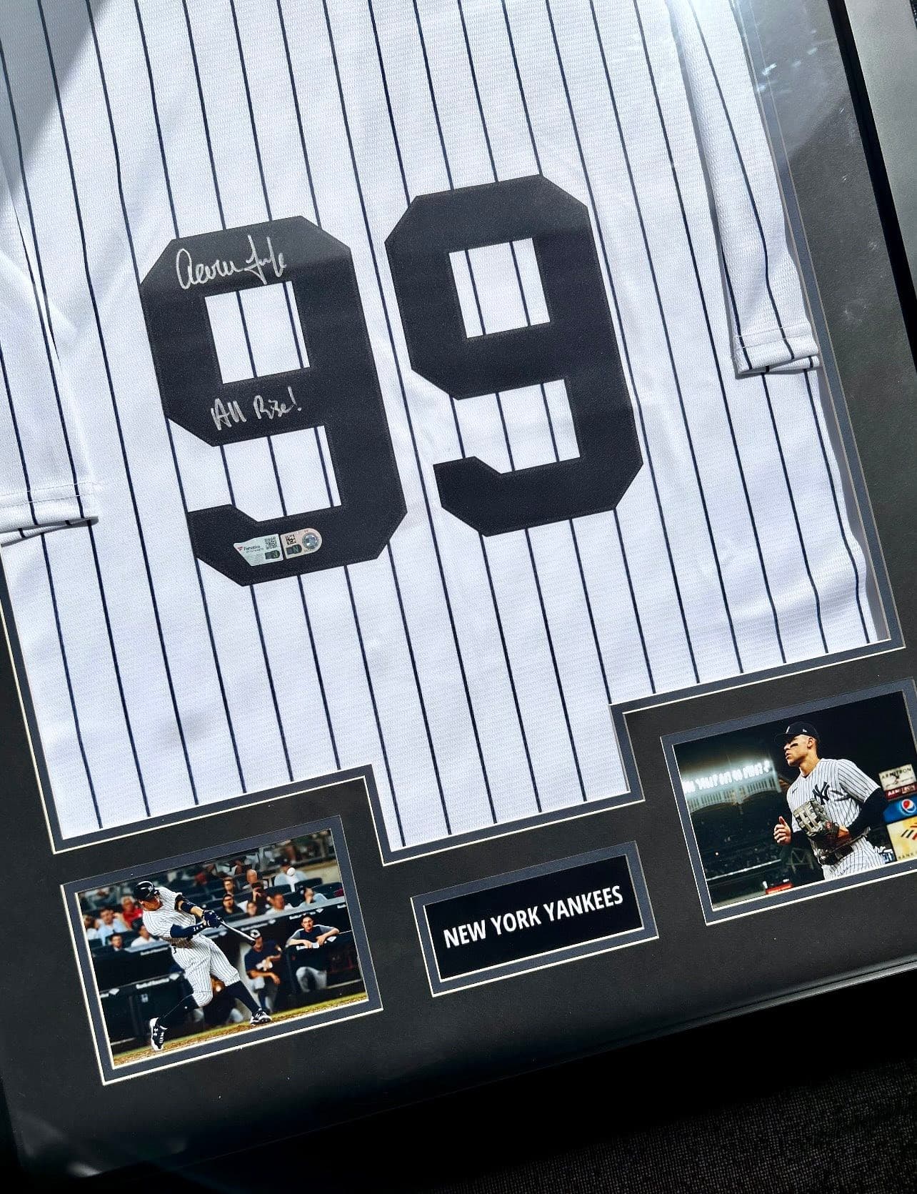 Signed Aaron Judge New York Yankees #99 pinstripe jersey inscribed 'All Rise!' framed with two action photos and engraved 'New York Yankees' nameplate