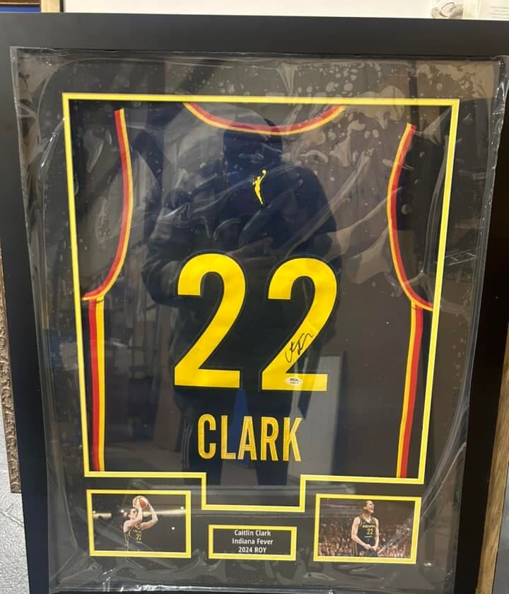 Autographed Caitlin Clark Indiana Fever #22 jersey framed in a shadow box with twin action shots and a '2024 ROY' nameplate