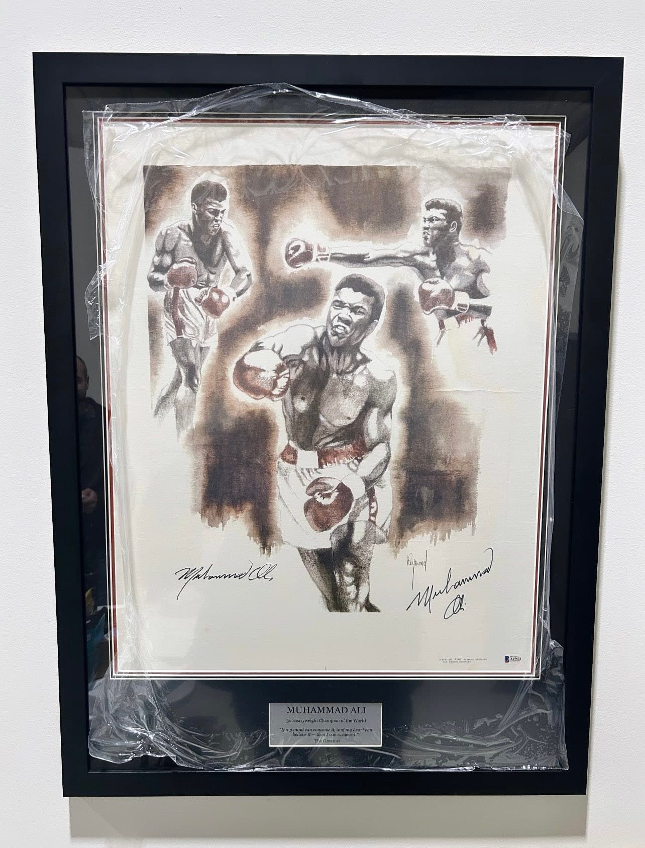 BAS-authenticated twice-signed Muhammad Ali charcoal sketch lithograph showing three Ali fight poses, framed in a black moulding with a 'Muhammad Ali - 3x Heavyweight Champion of the World - The Greatest' nameplate