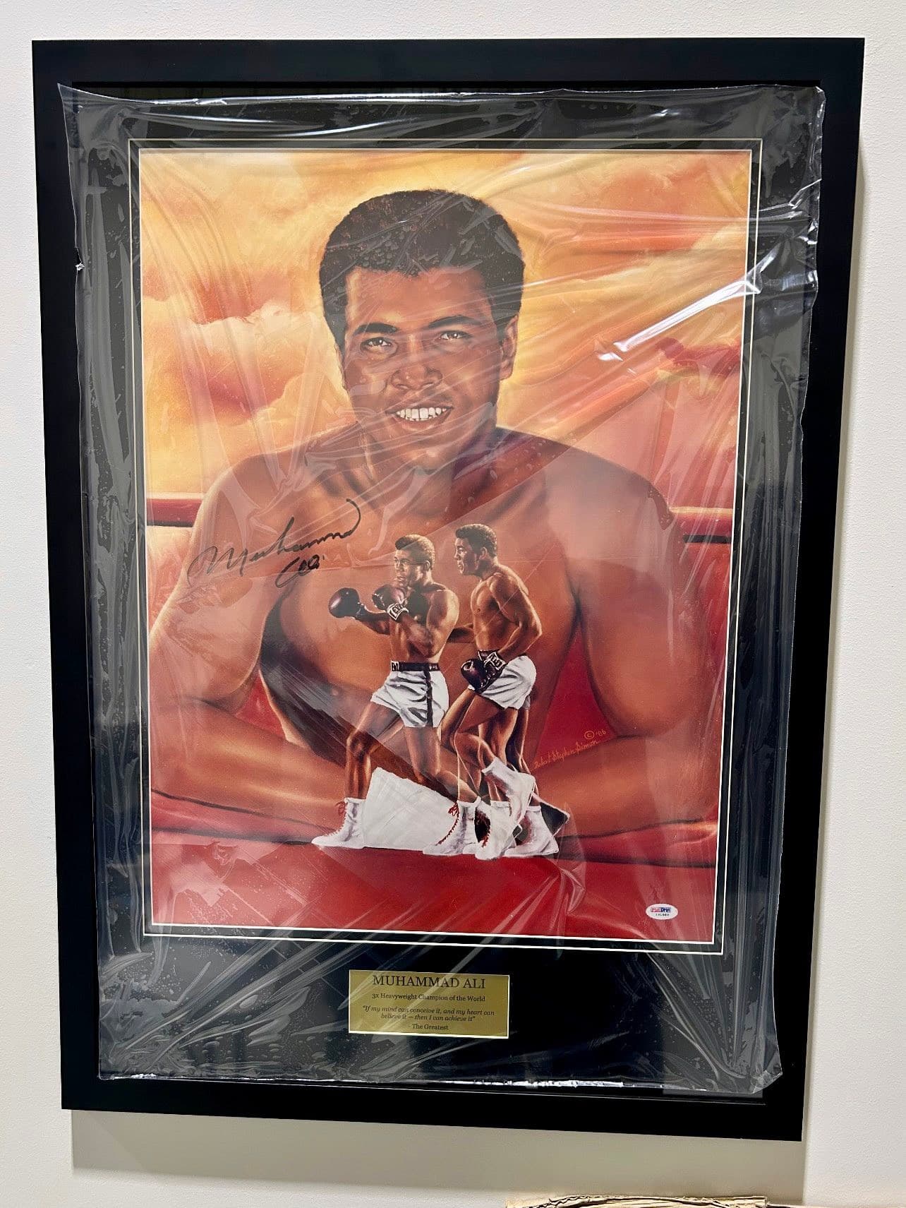 PSA-authenticated signed Muhammad Ali painted portrait lithograph showing a head-and-shoulders Ali with an inset Liston knockout fight scene over an orange ring background, framed in a black moulding with a gold '3x Heavyweight Champion of the World' nameplate