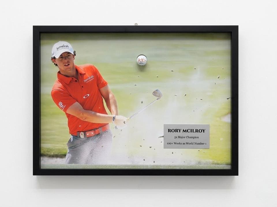 Signed Rory McIlroy bunker action shot framed in a thin black moulding with engraved 'Rory McIlroy - 5x Major Champion' nameplate