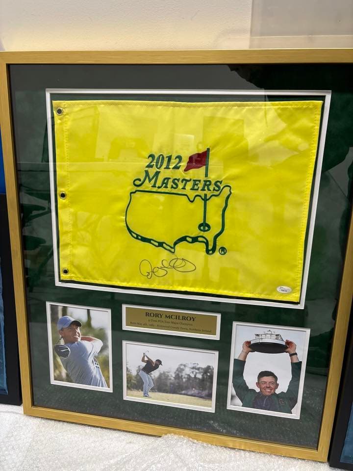 Signed Rory McIlroy 2025 Masters Tournament Augusta National pin flag framed in a black moulding with green double mat and engraved tournament nameplate
