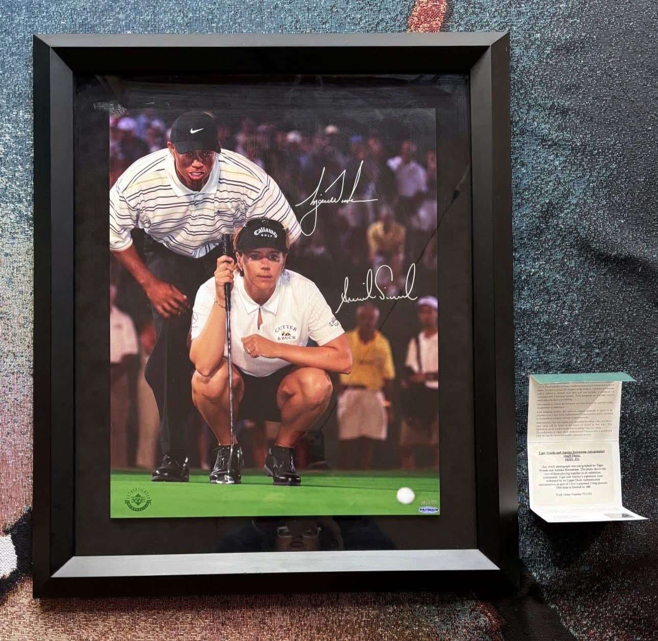 Dual-signed Tiger Woods and Annika Sorenstam putting-green shot framed in a black moulding, JSA authenticated