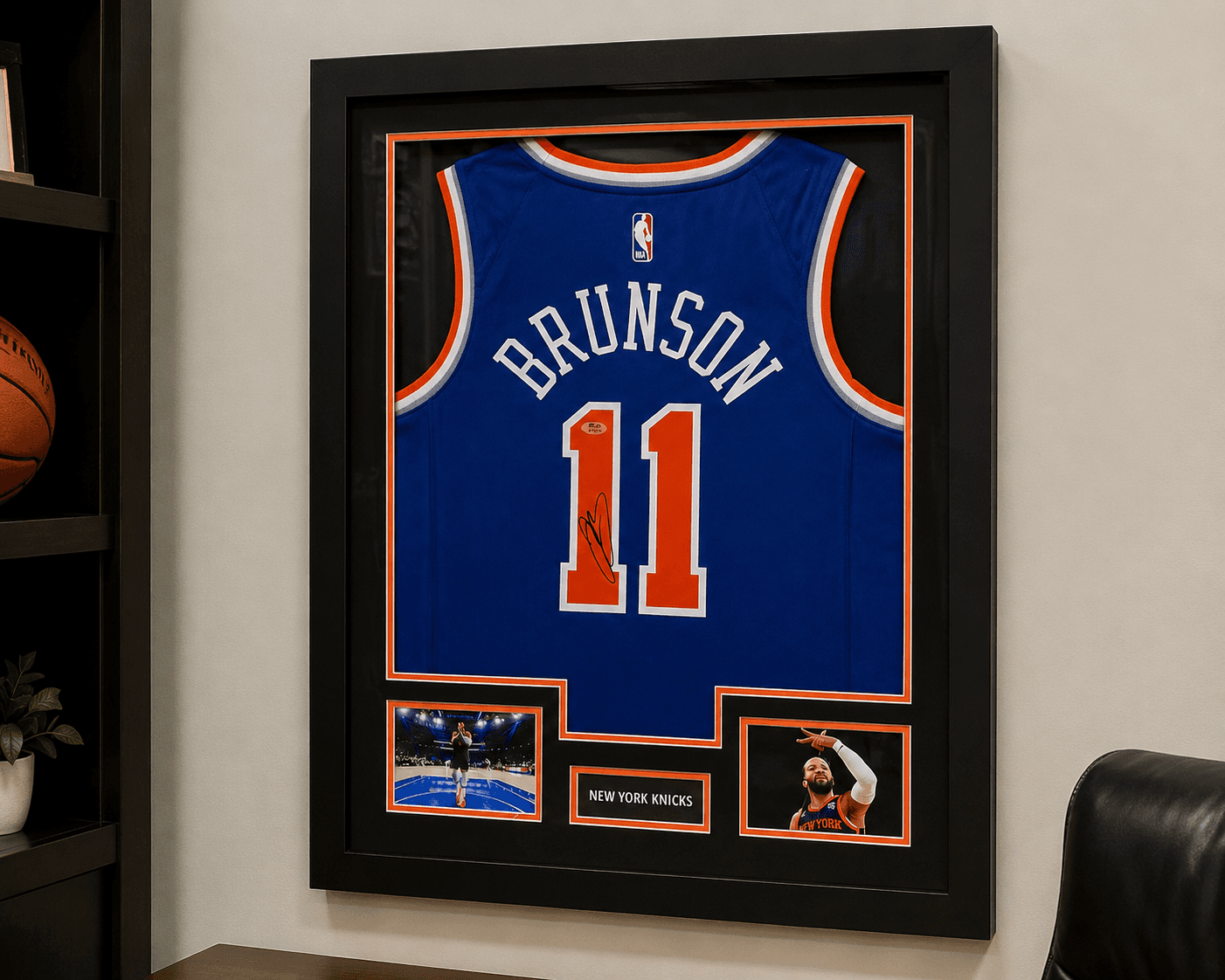 Autographed Jalen Brunson New York Knicks #11 jersey framed in a custom shadow box with orange and blue matting, displayed in a home office