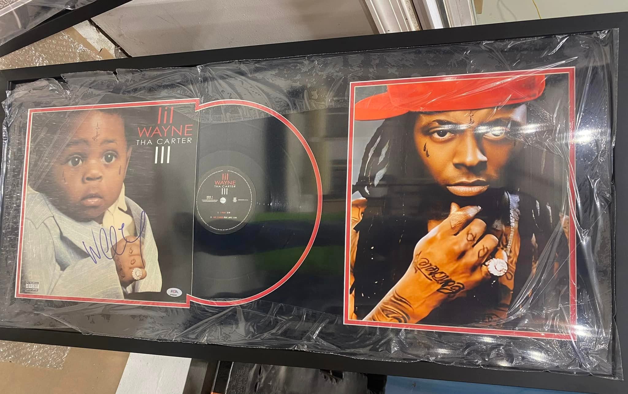 Signed Lil Wayne Tha Carter III double LP framed in a black moulding with the album jacket alongside the vinyl record and a signed Lil Wayne photo