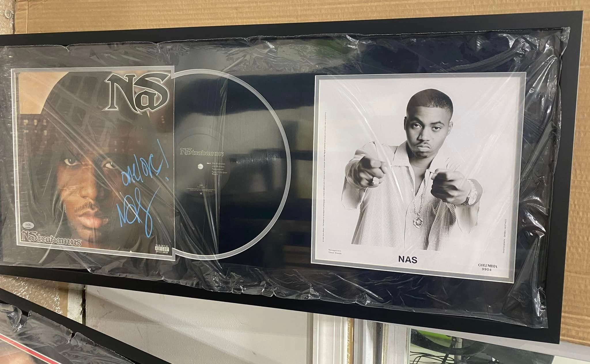 Signed Nas Nastradamus double LP framed with the album jacket, two vinyl records, and an authenticated signed photo of Nas in a black moulding