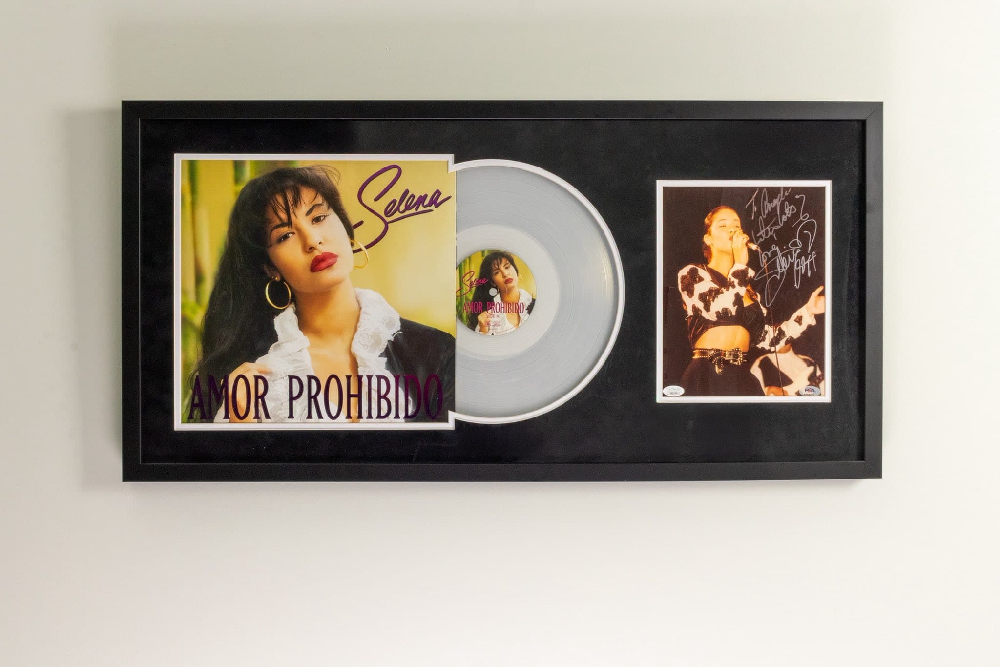 Signed Selena Amor Prohibido LP framed with the album jacket on the left, the EMI Latin vinyl mounted at center, and a signed Selena promotional photo on the right inside a black moulding