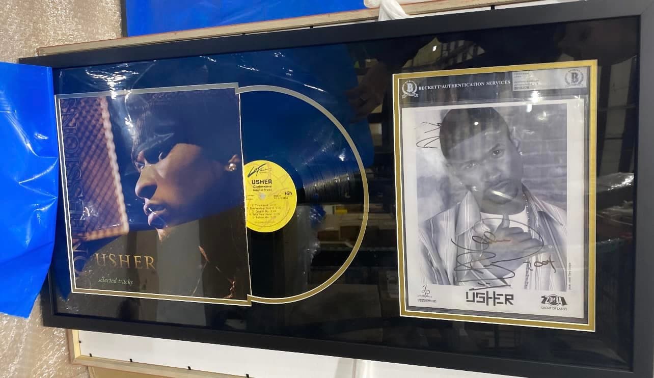 Signed Usher Confessions LP framed with the album jacket, vinyl record, and a signed Usher photo in a black moulding