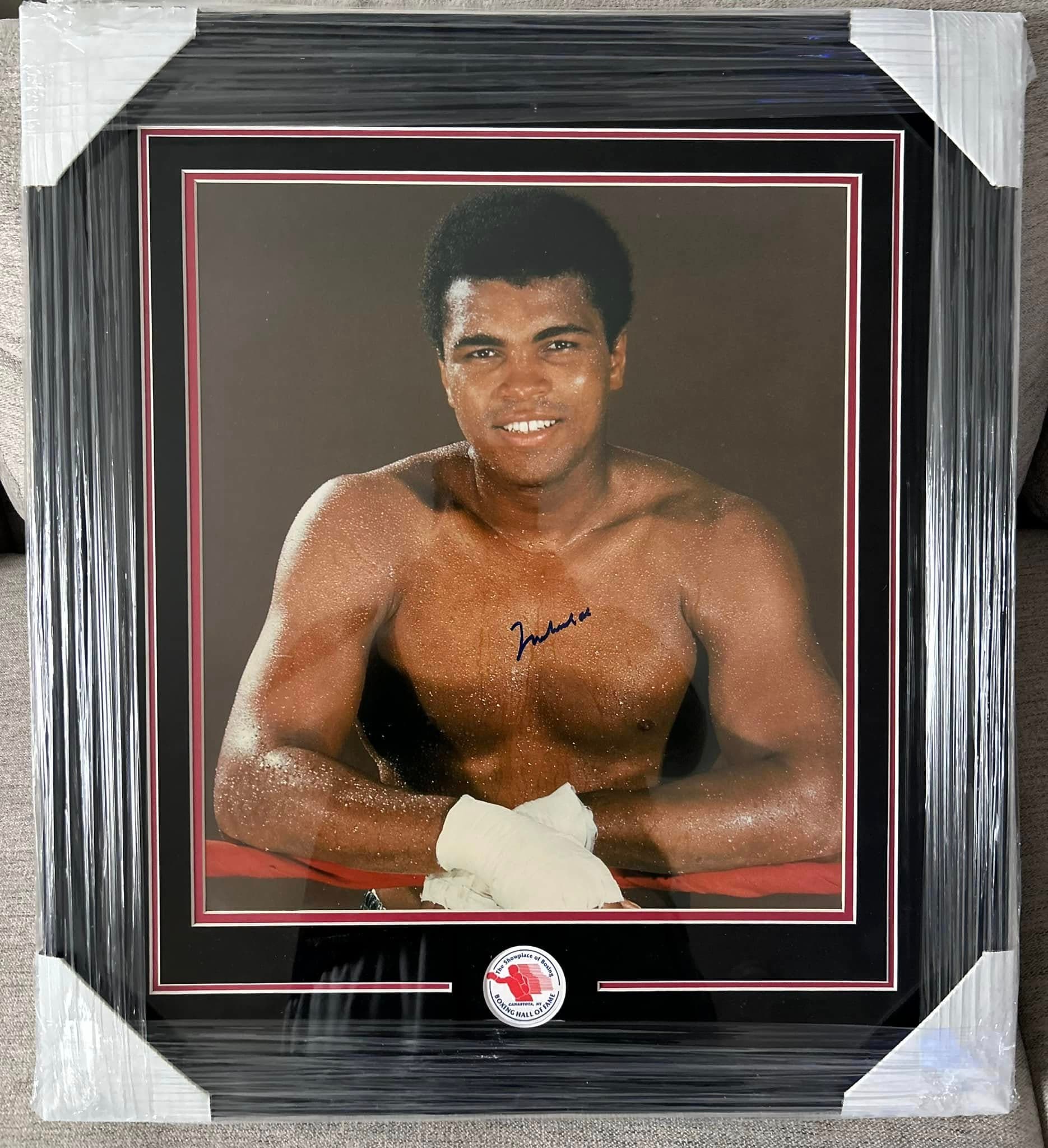 Boxing Hall of Fame authenticated signed Muhammad Ali shirtless portrait photo framed in a black moulding with a black mat and red accent border, with the round Boxing Hall of Fame COA sticker visible at the bottom of the mat