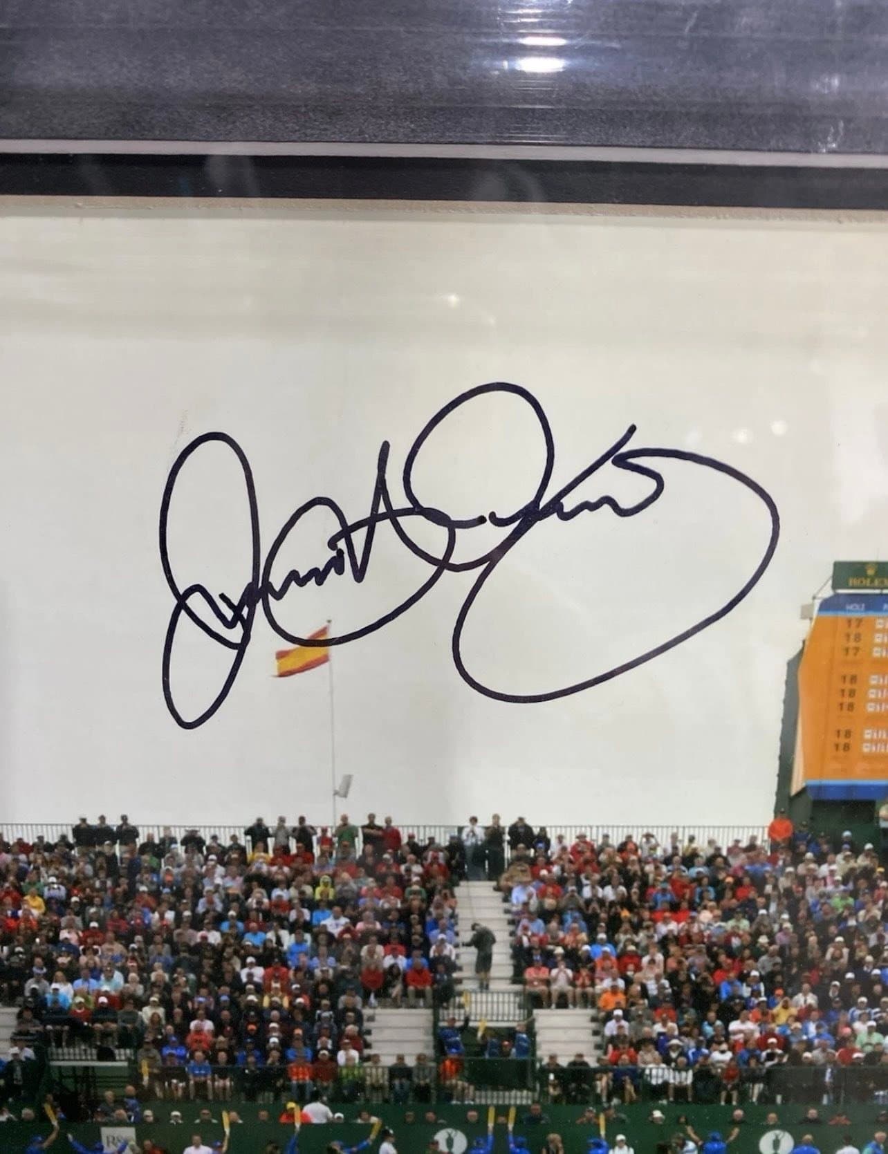 Bold sharpie signature of Jose Maria Olazabal across the sky of a large Augusta National print, framed in a black moulding