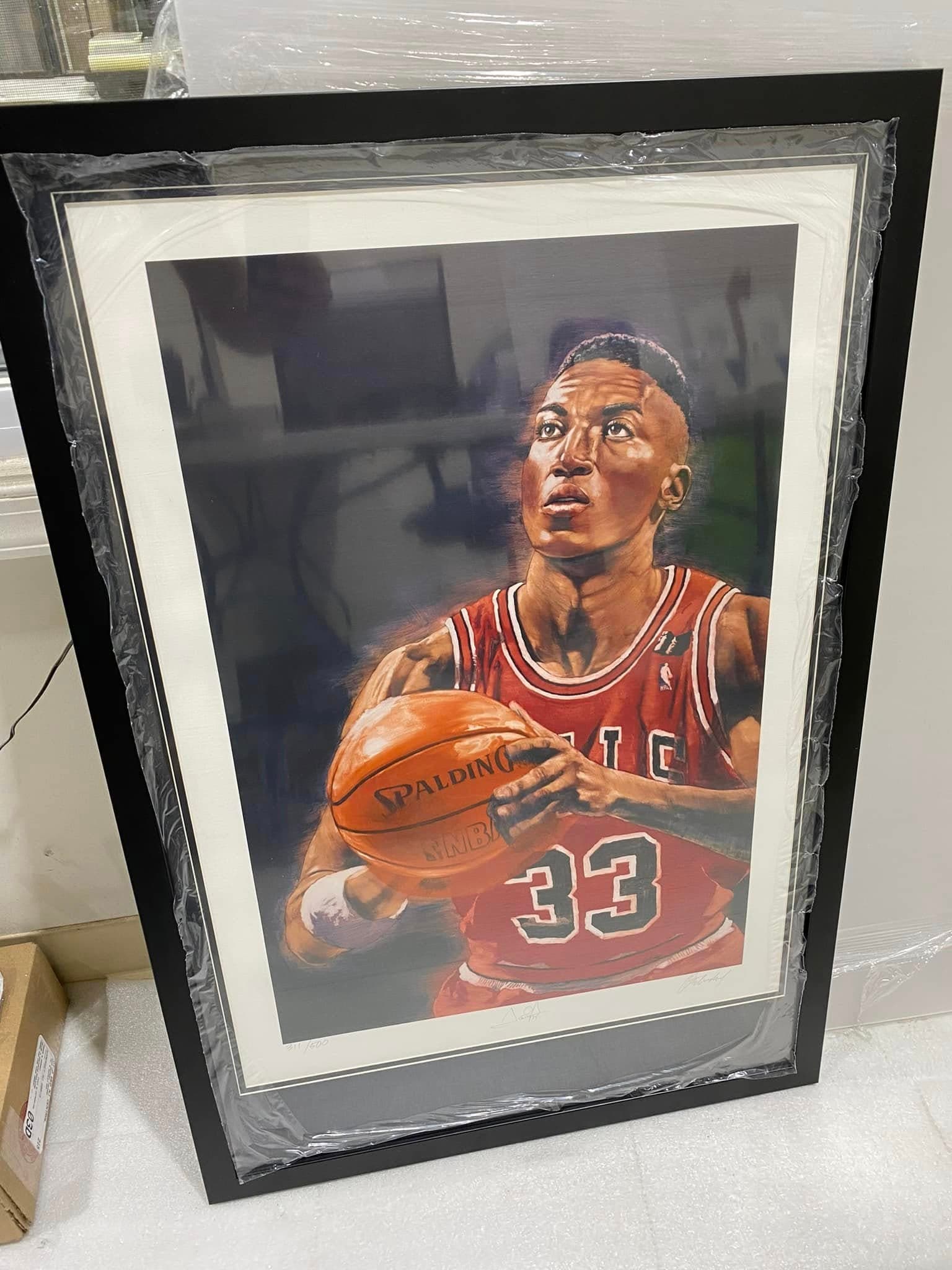 Numbered signed Scottie Pippen Chicago Bulls #33 portrait lithograph print framed in a black moulding with a white mat