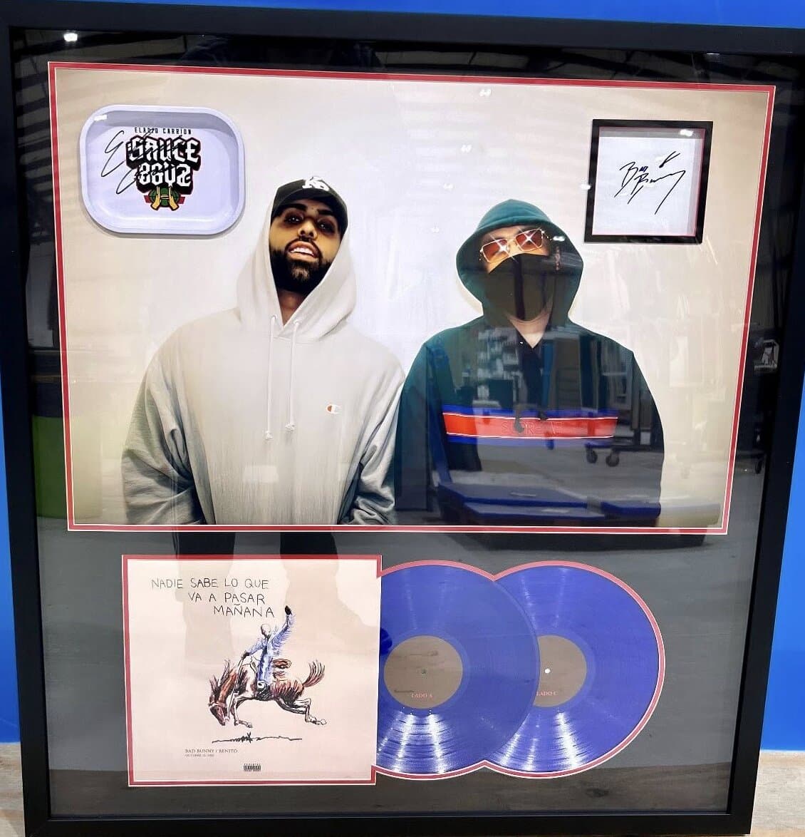 Shadow box framing example: signed Bad Bunny double vinyl record and art card mounted in deep shadow box display