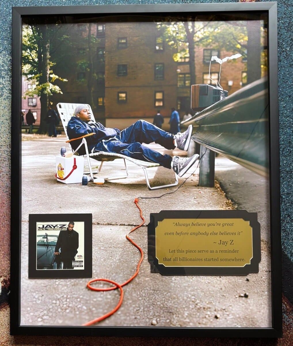 Shadow box framing example: signed Jay-Z Vol. 2 poster and CD cover mounted in shadow box with etched nameplate