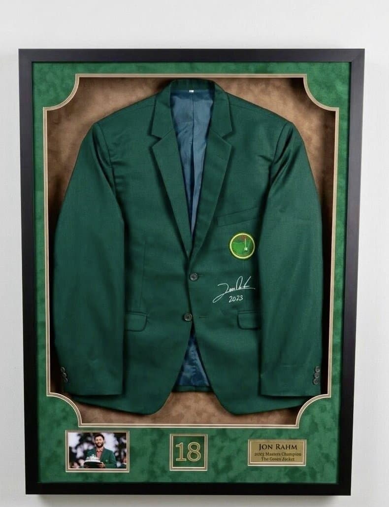 Shadow box framing example: Jon Rahm 2023 Masters green jacket displayed with championship nameplate and event prints