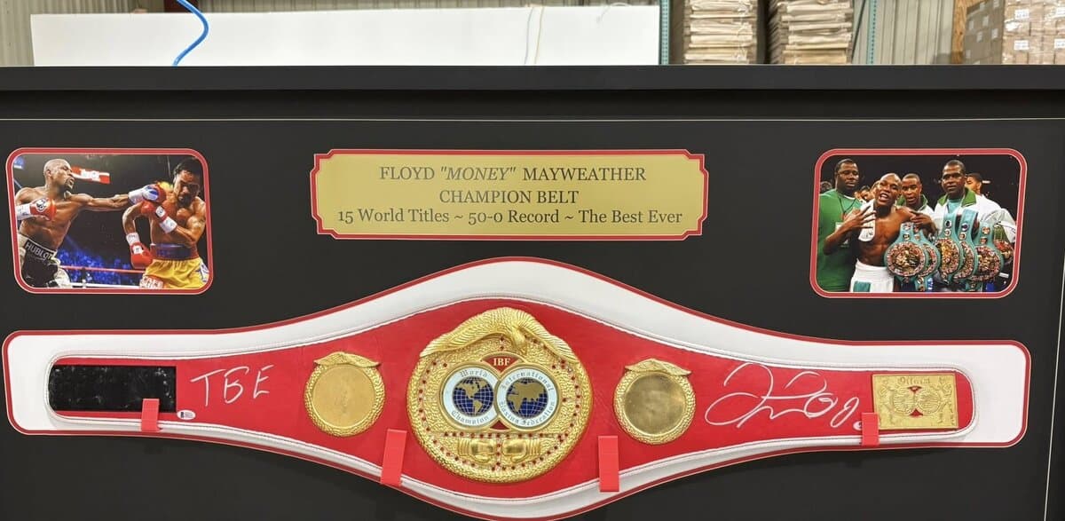 Shadow box framing example: Floyd Mayweather IBF championship belt mounted in panoramic shadow box with action prints