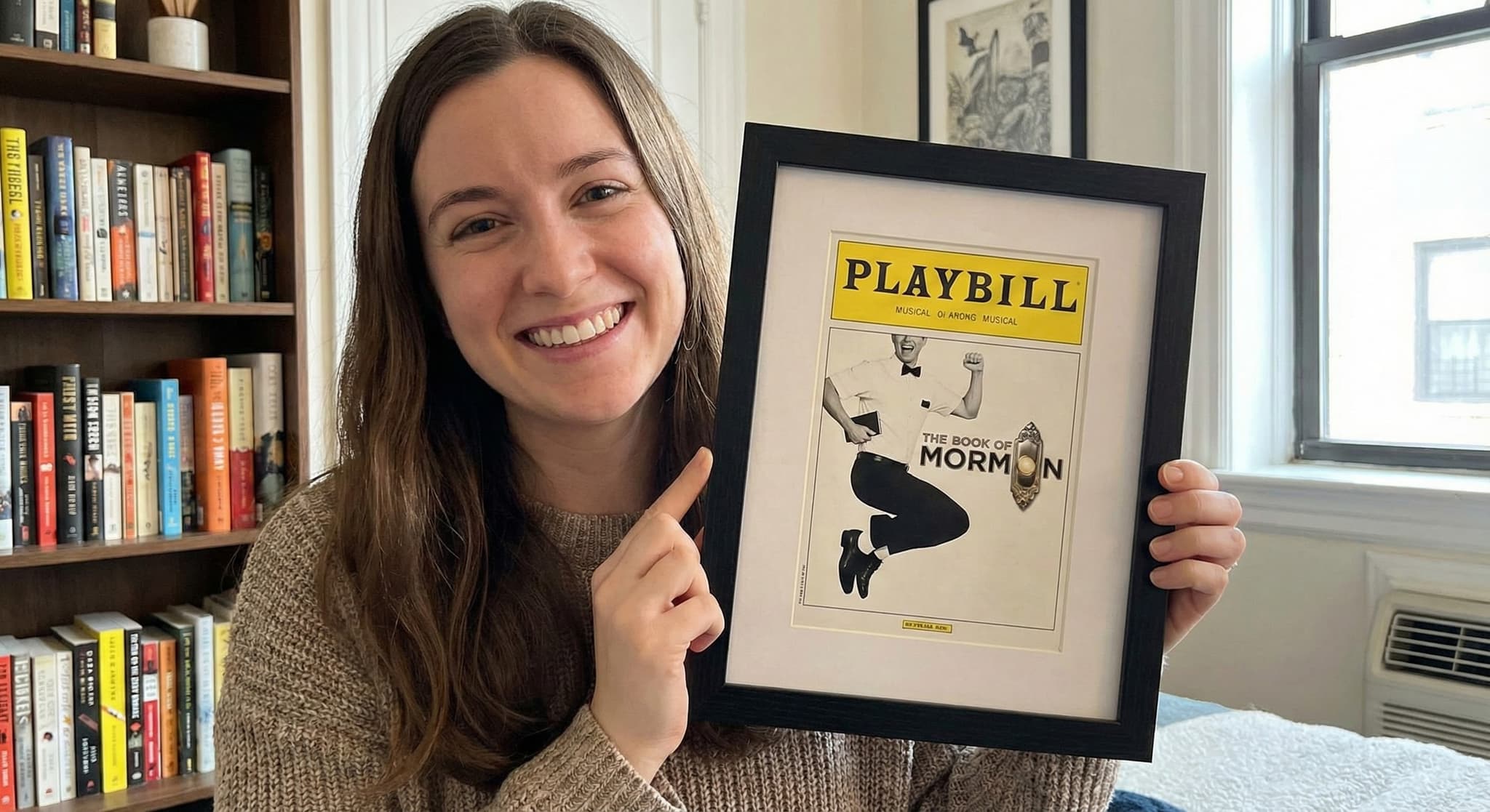 Framed Broadway playbill styled on a wall