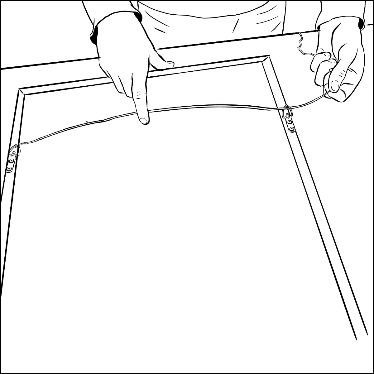 A hand stretching picture wire across the back of a wood picture frame from the first D-ring toward the second, with a small amount of slack visible in the middle.