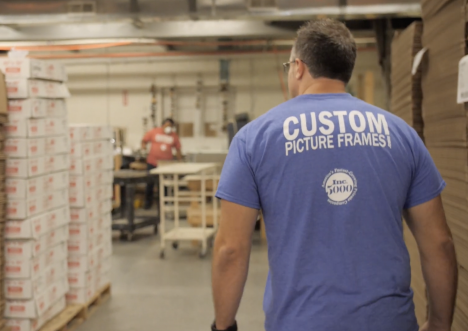 Man in a t-shirt with custom picture frames logo